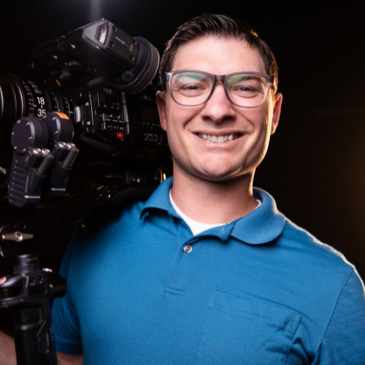Adam Garceau, founder of Nudge Planner, holding a cinema camera